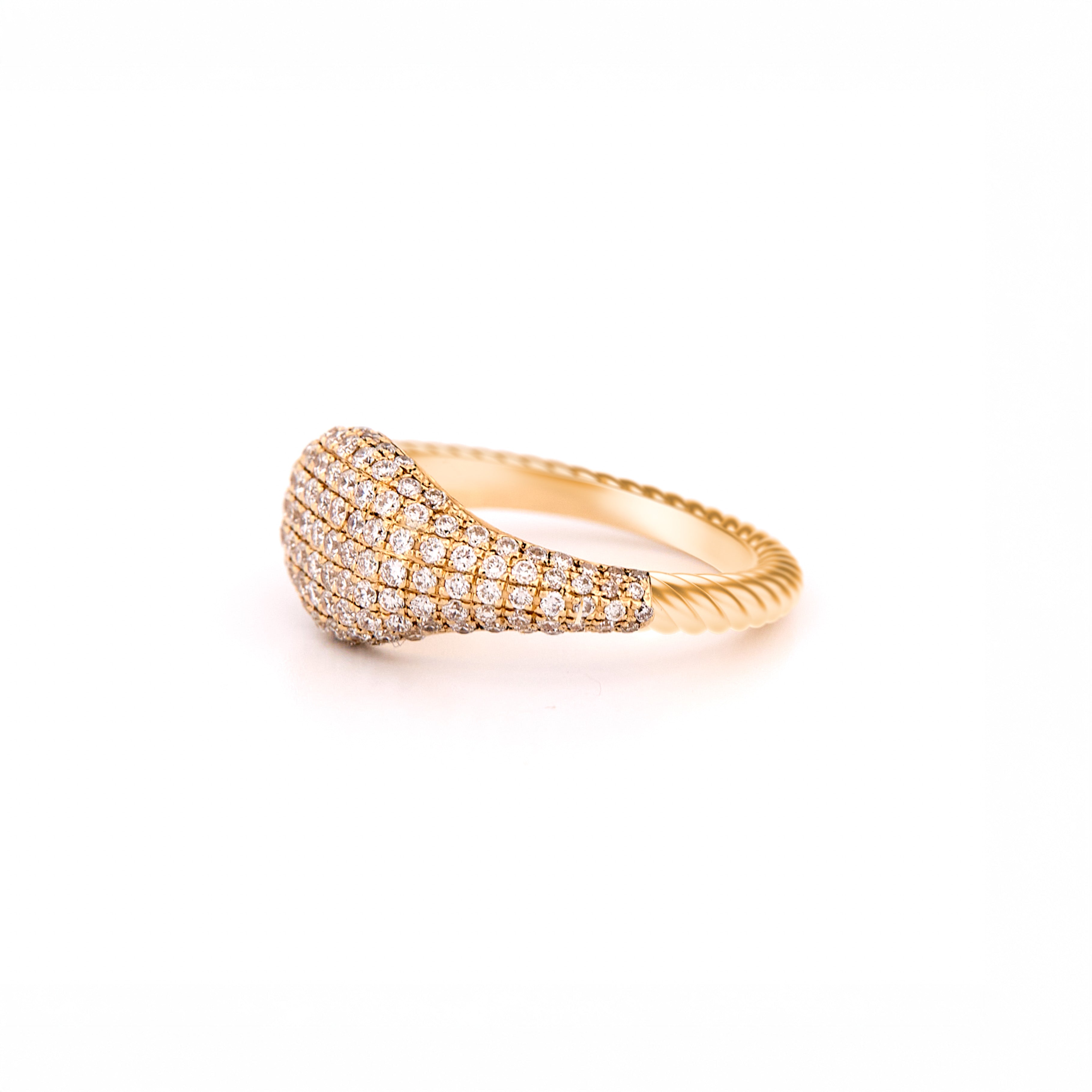 Gold ring with pave diamonds accents and a twisted gold band on a white background