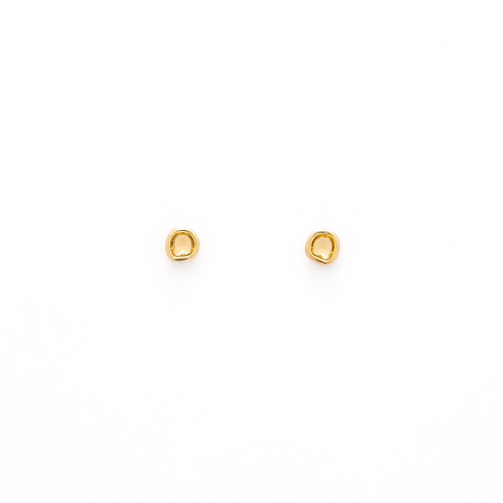 A pair of gold-colored studs earrings with a simple design, resembling a prayer bowl or birds' nest, displayed against a white background.