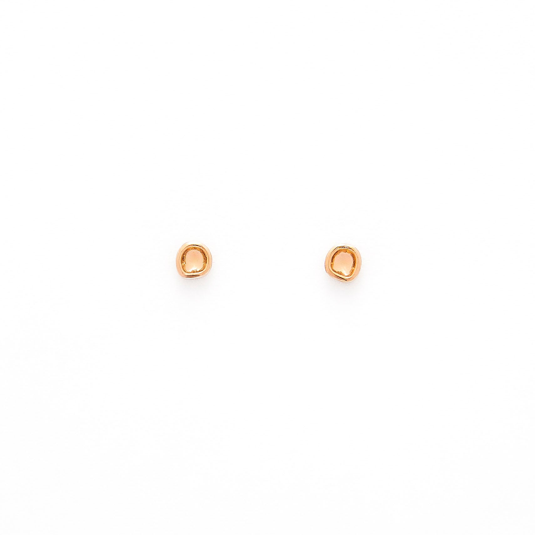 A pair of gold studs earrings with a simple design, resembling a prayer bowl or birds' nest, displayed against a white background.