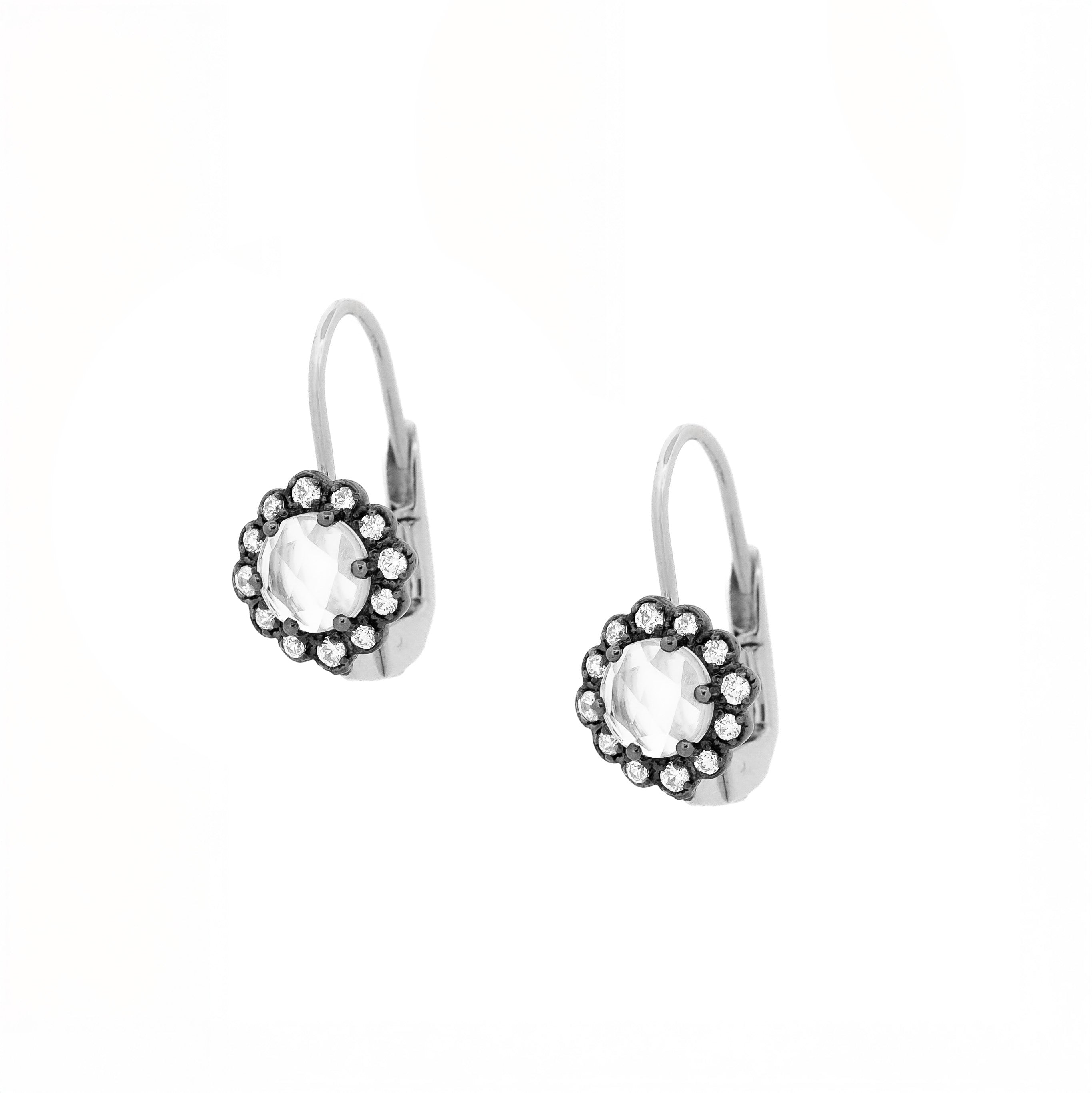 white gold earrings with rose cut diamond as a center stone surrounded by am array of round diamonds set in a black gold flower setting.