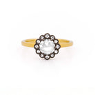 Gold ring with a central diamond surrounded by black plated gold and smaller diamonds on a white background