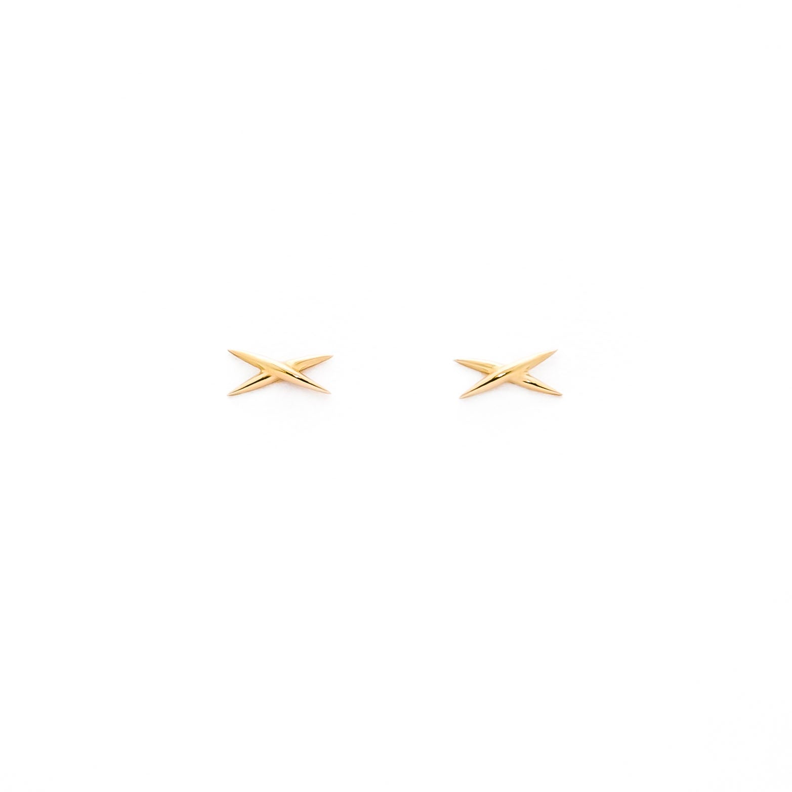 A pair of gold stud earrings shaped like an X on a white background.