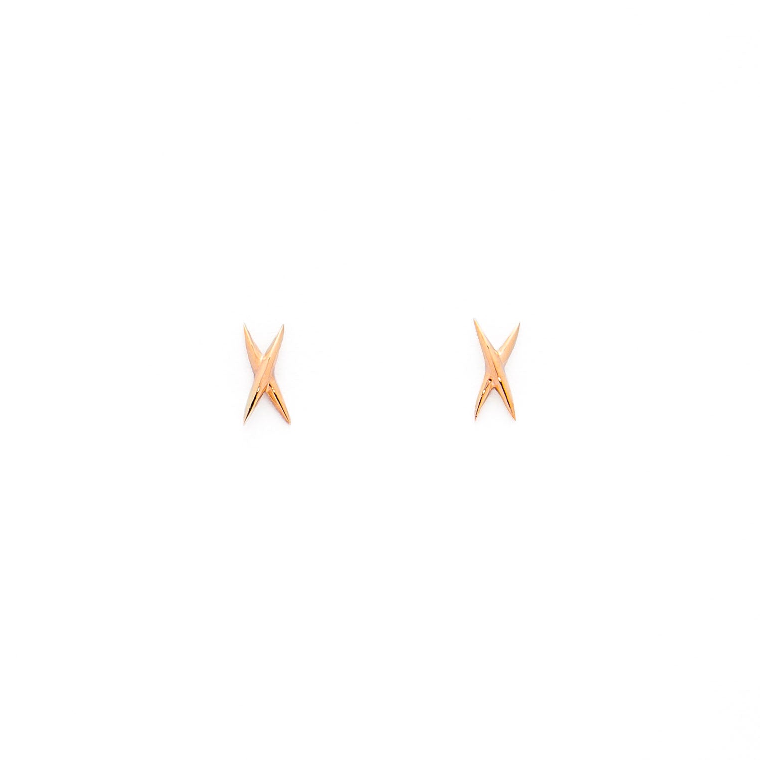 A pair of gold stud earrings shaped like an X on a white background.