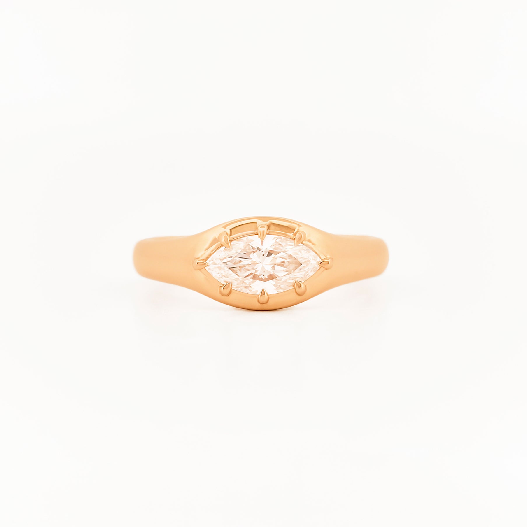 Signet Pinky Diamond ring, in yellow gold, on a with a white background