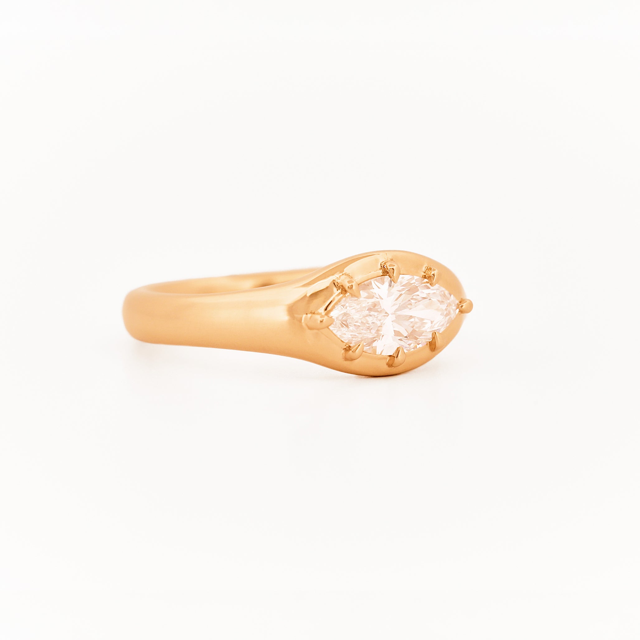 Signet Pinky Marquise Diamond ring, in yellow gold, on a with a white background