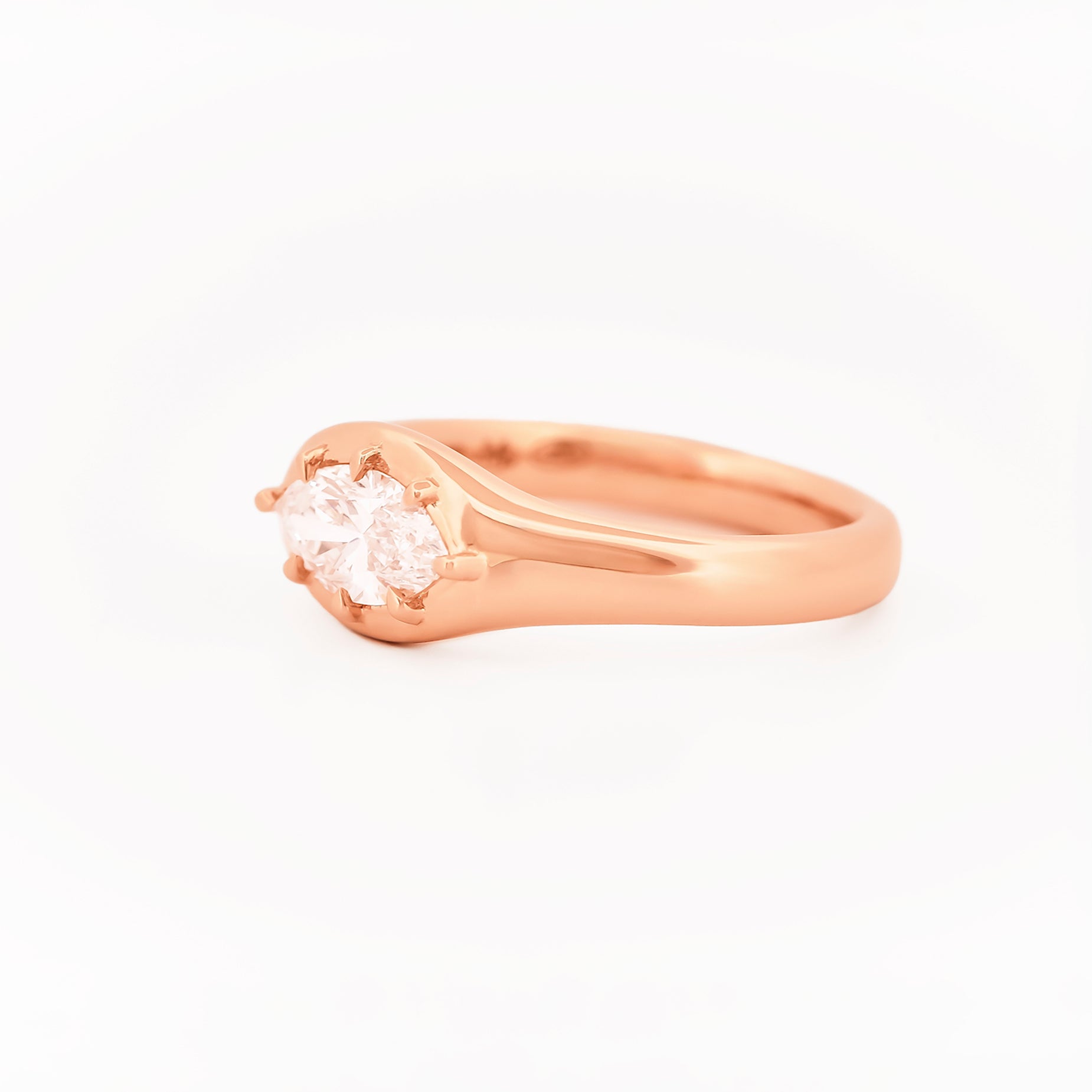 Signet Pinky Marquise Diamond ring, in rose gold, on a with a white background