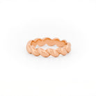 Rose Gold ring with a braided design on a white background