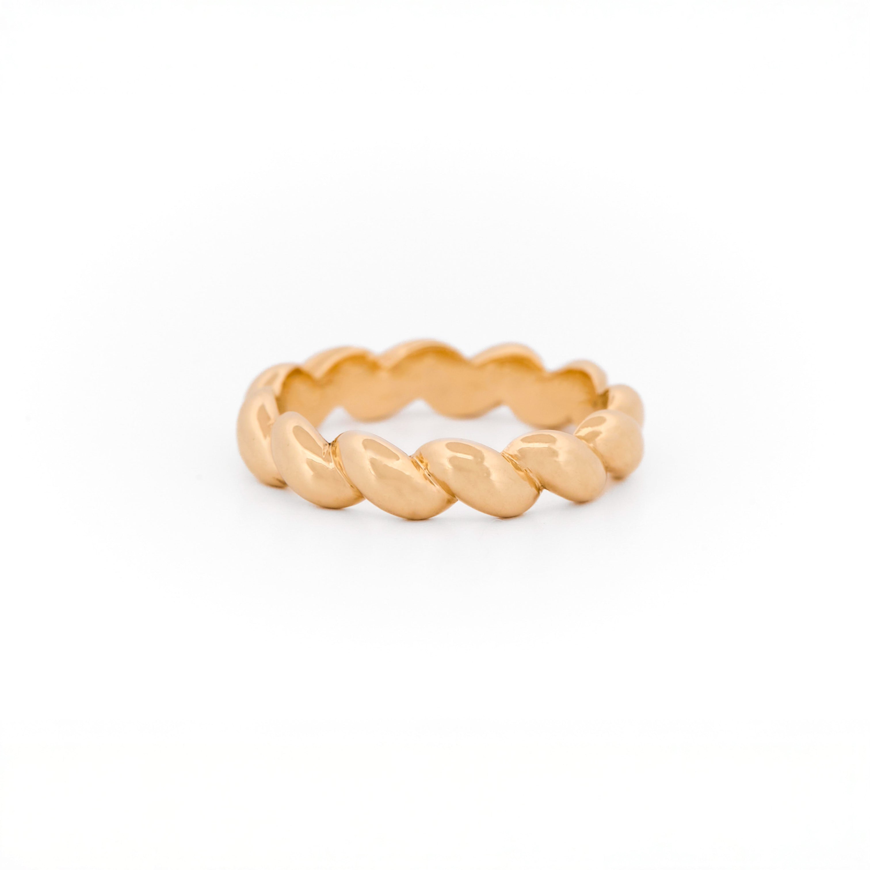 Yellow Gold ring with a braided design on a white background