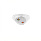 Gold ring with embedded gemstones on a white background, the stones are set inside 2 stars