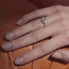 hexagon diamond ring on hand.