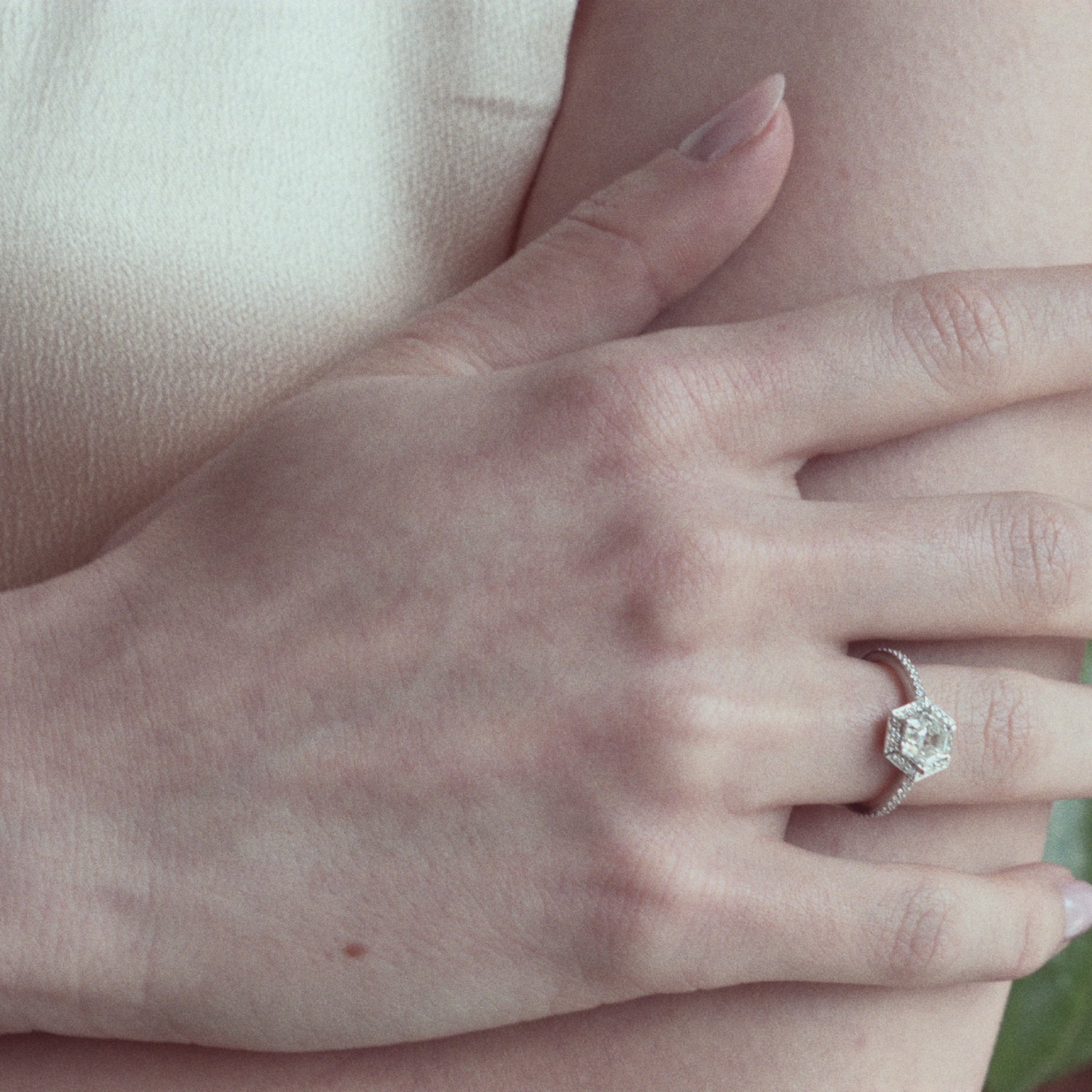 hexagon diamond ring on hand.